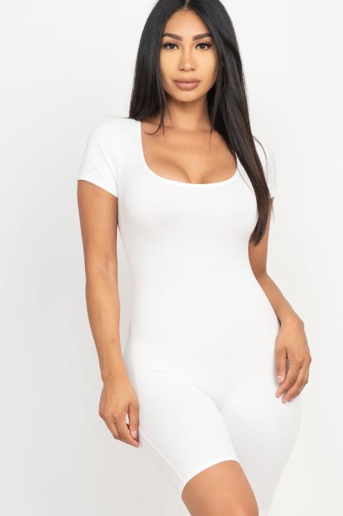 Woman wearing a white short sleeve scoop neck bodycon romper made from stretchy polyester and spandex, showcasing a comfortable fit.