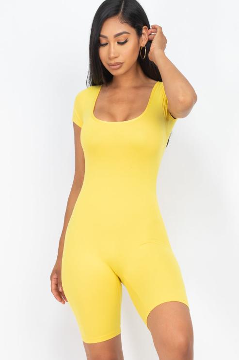 Model wearing a yellow short sleeve scoop neck bodycon romper, showcasing the tight yet comfortable fit and stretchy fabric.
