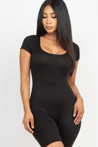 Model wearing black short sleeve scoop neck bodycon romper, showcasing stretchy fit and sleek design. Fabric: 92% Polyester, 8% Spandex.