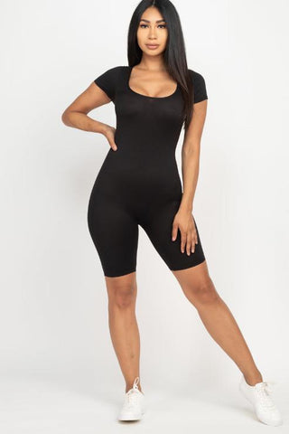 Model wearing black short sleeve scoop neck bodycon romper; stretchy, lightweight fabric with a tight yet comfortable fit.