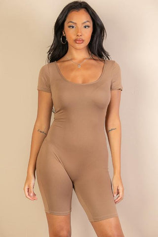 Model wearing a short sleeve scoop neck bodycon romper in beige, showcasing a tight yet comfortable fit. Fashion outfit, women's clothing.