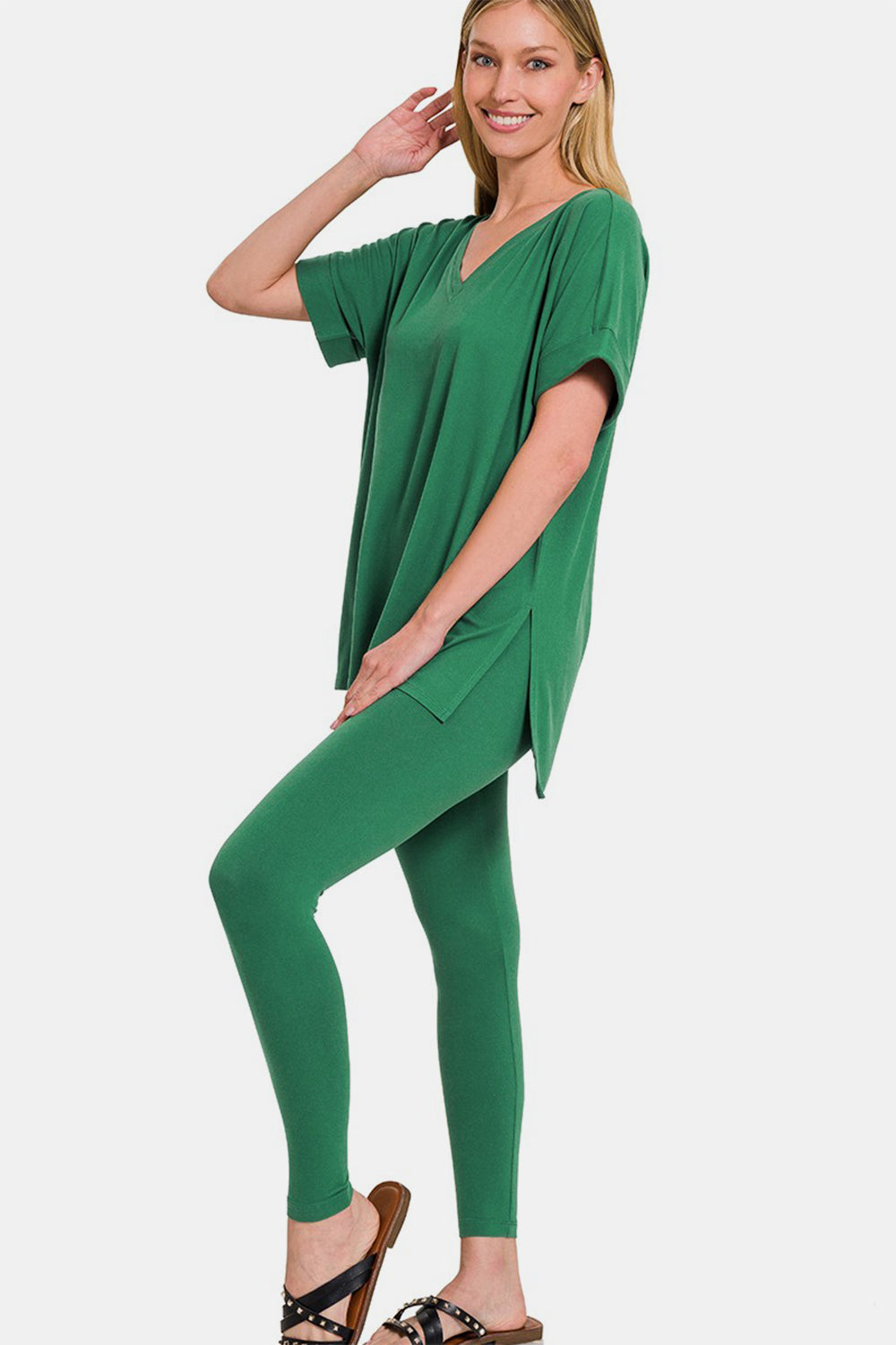 Woman wearing green V-neck rolled short sleeve T-shirt and leggings lounge set, showcasing comfortable and chic style.