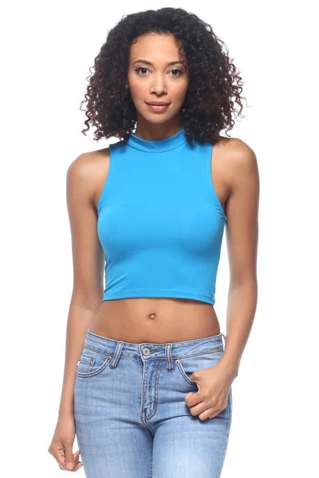 Blue sleeveless mock neck crop top in stretch knit fabric, featuring a fitted design and solid color, worn by a model in jeans.