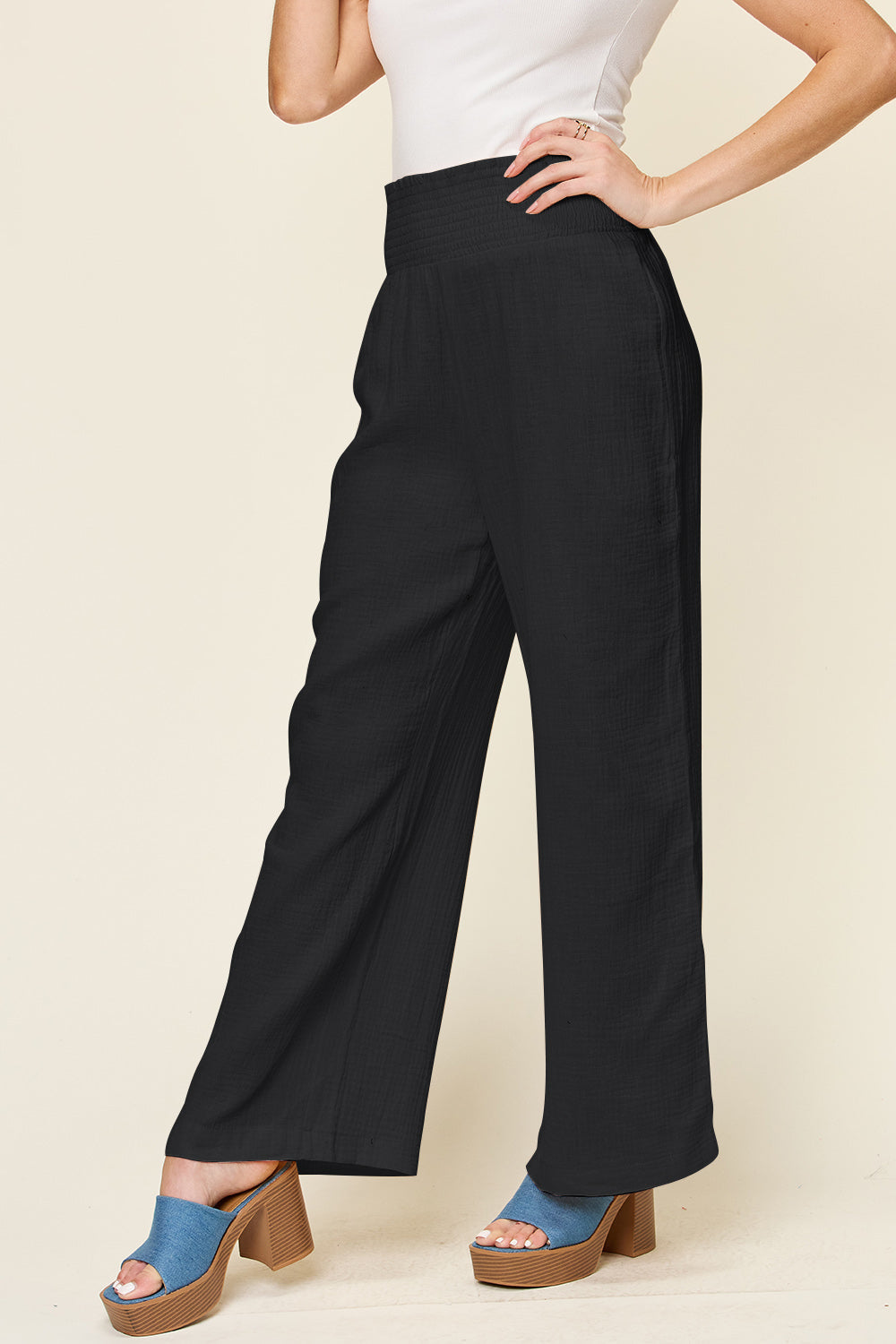 "Texture Smocked Waist Wide Leg Pants in black, 100% cotton, featuring a smocked waist design for a comfortable fit."