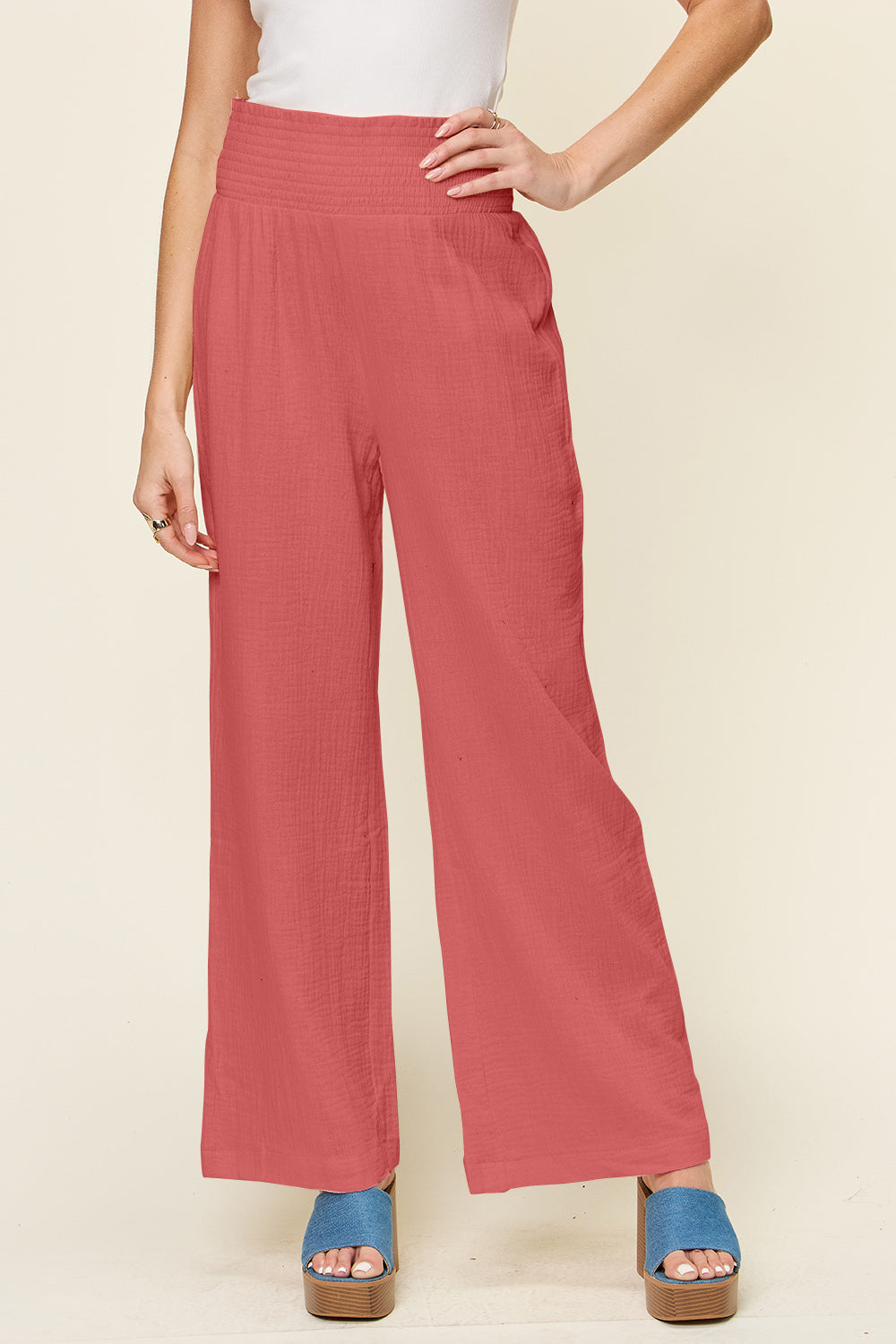 Texture smocked waist wide leg pants in coral, 100% cotton, opaque fabric with stylish design.