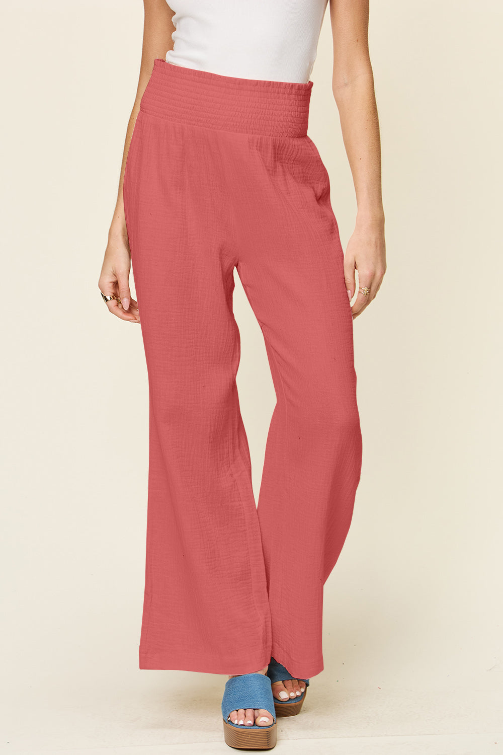 Stylish red smocked waist wide leg pants made from 100% cotton, perfect for a chic and comfortable look.