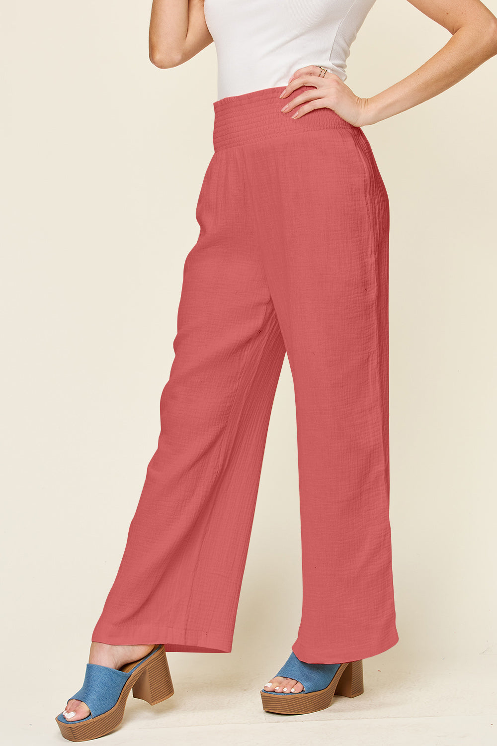 Texture smocked waist wide leg pants in red, 100% cotton, opaque design, stylish fashion item shown with a model wearing blue platform sandals.