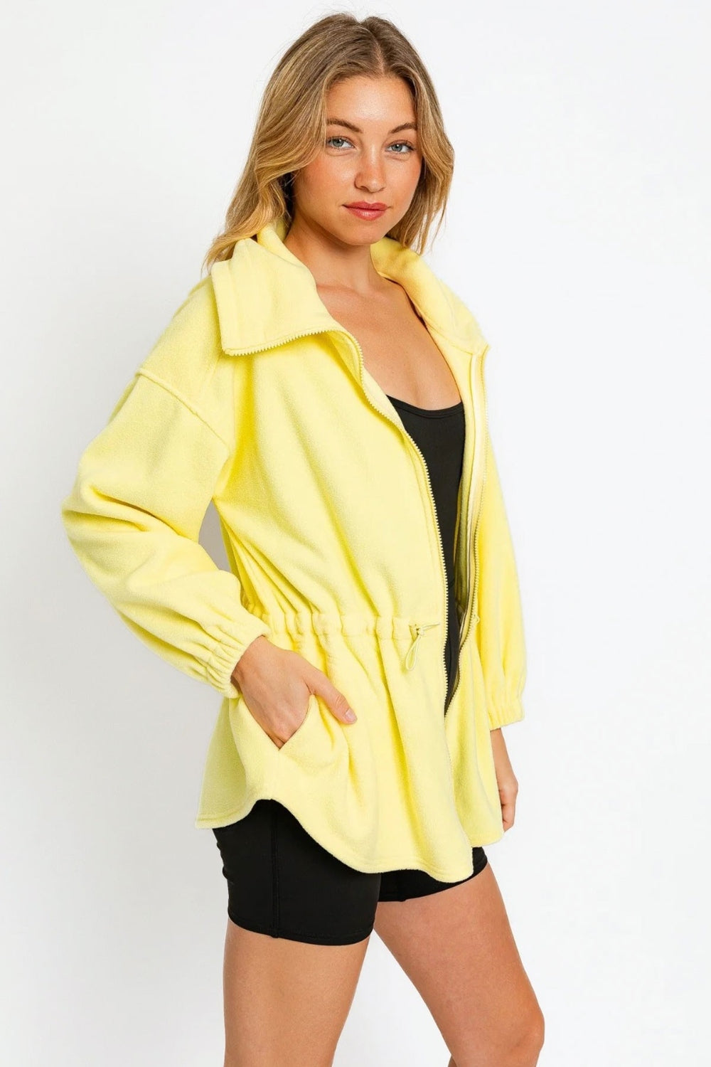 Yellow zip-up waist drawstring soft fleece jacket in polyester, featuring ruched details and pockets, casual stylish outerwear.