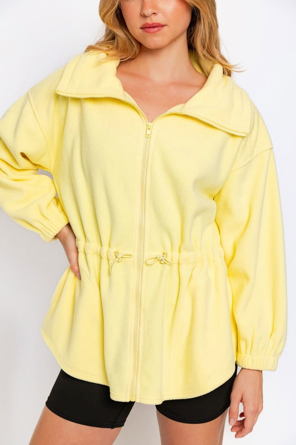 Yellow zip-up waist drawstring soft fleece jacket with ruched detailing and normal thickness, made from 100% polyester.