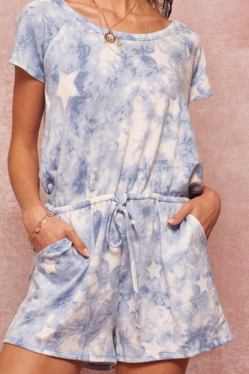 Star-pattern tie-dye knit romper with round neckline, short raglan sleeves, open back, drawstring waist, side pockets, relaxed fit.