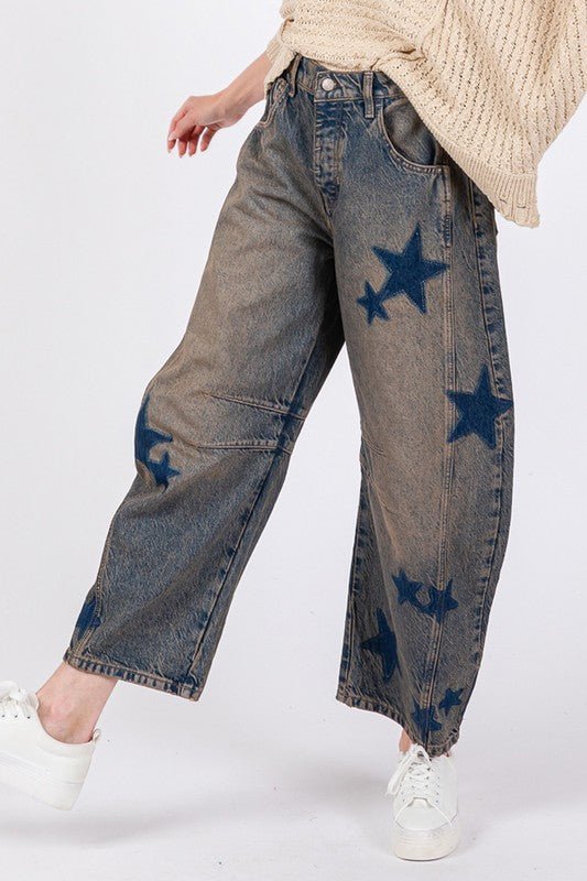 Star wide leg jeans with pockets, featuring blue star design and slightly stretchy 100% cotton fabric, paired with white sneakers.