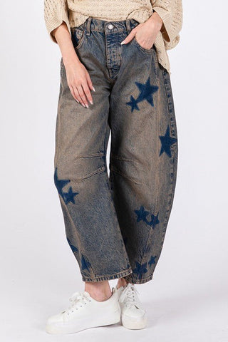 Woman wearing star wide leg jeans with pockets, slightly stretchy, 100% cotton, casual style, paired with white sneakers.