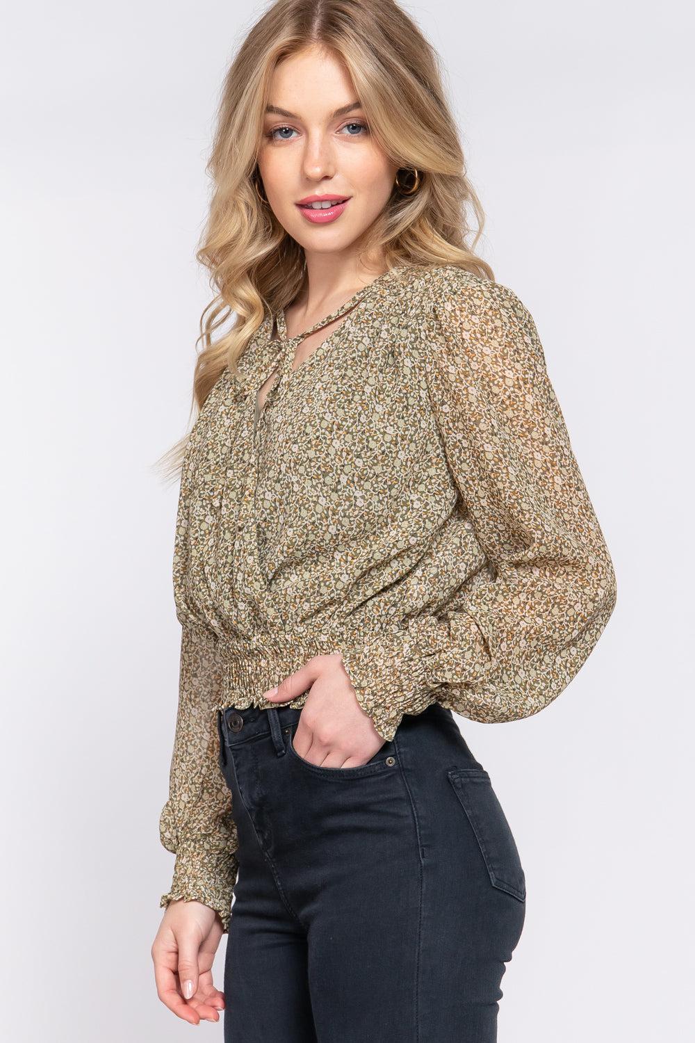 Olive floral print chiffon blouse with smocked waist and long sleeves, featuring a surplice front and tie detail.