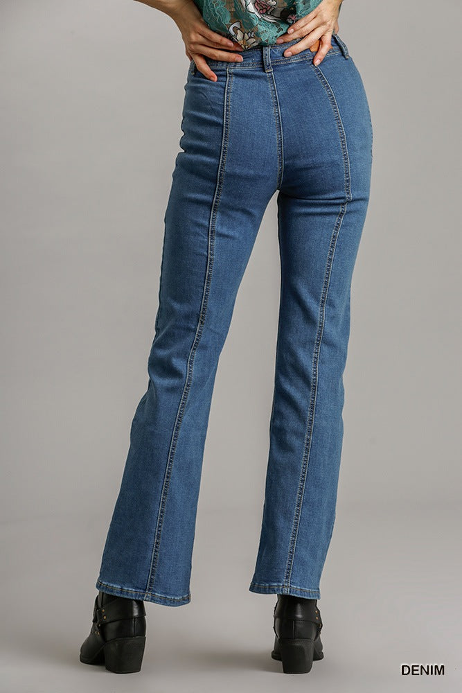 Woman wearing straight cut denim jeans with pockets, showcasing back panel design in blue denim fabric.