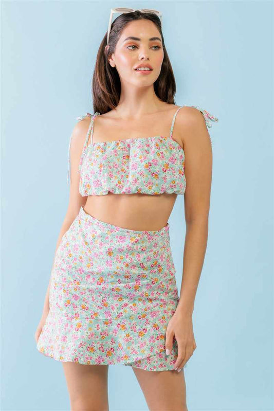 Trendy floral strappy crop top and high waist mini skirt set in mint fuchsia print, featuring self-tie straps and wrap hem design.