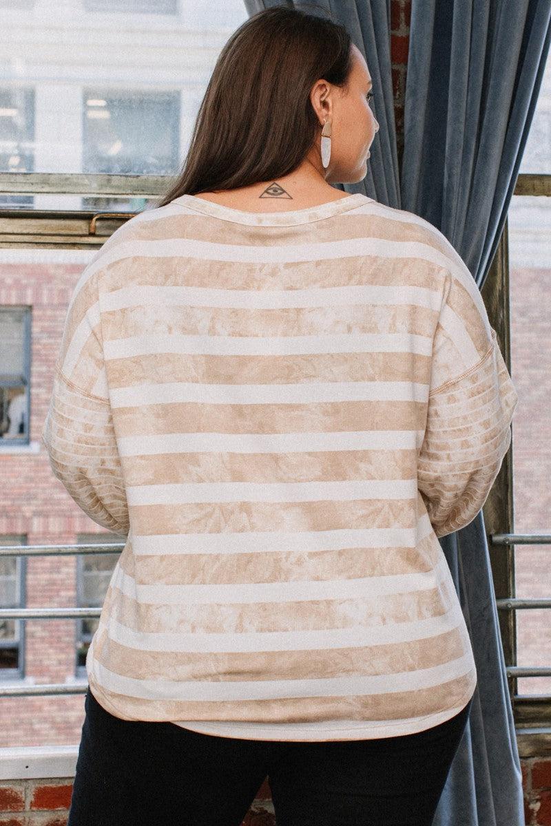 Woman wearing stripe printed taupe French terry top with contrast long sleeves and round neckline, viewed from the back.