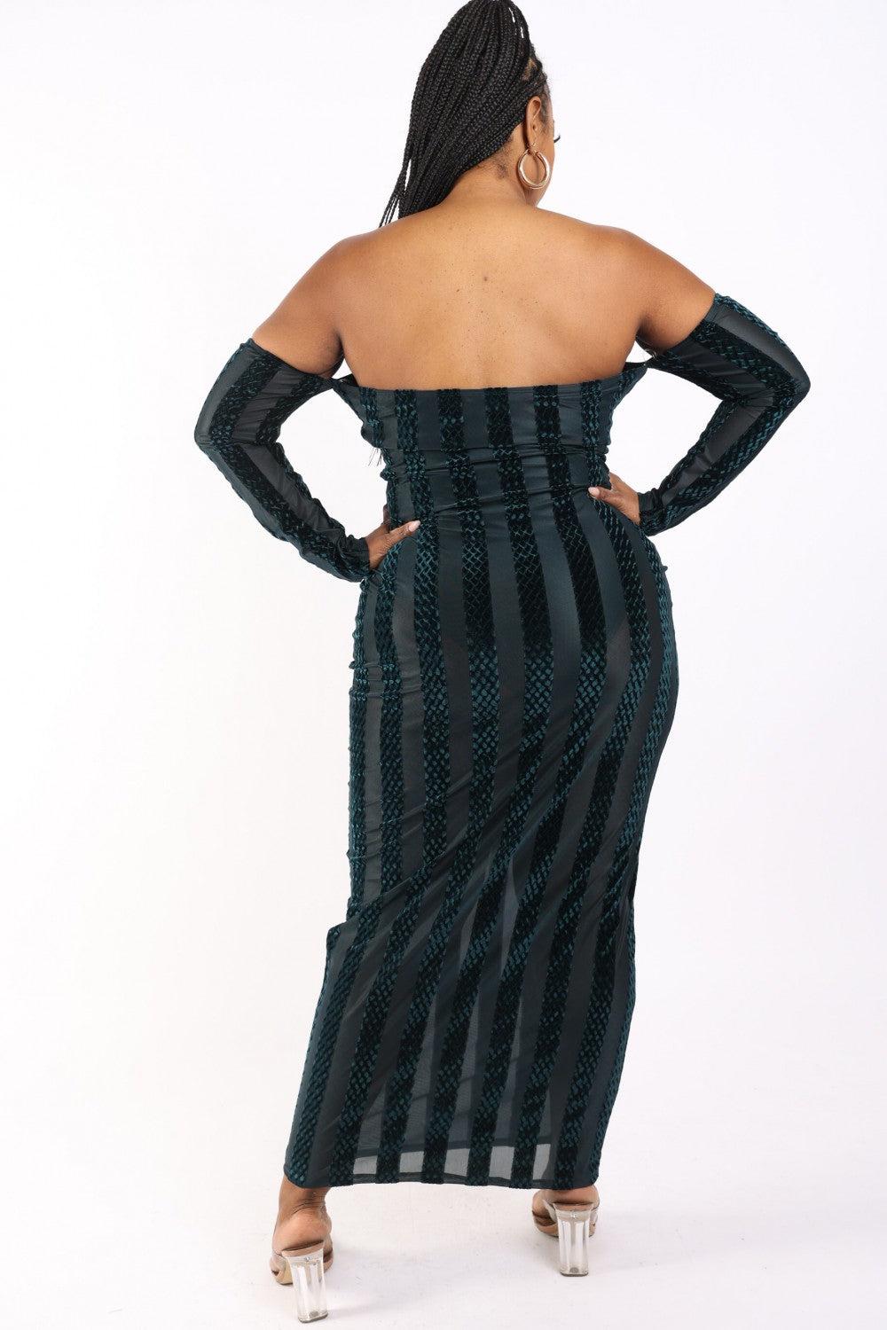 Plus size model wearing a hunter-striped velvet off-shoulder dress, showcasing back view with long sleeves and elegant design.