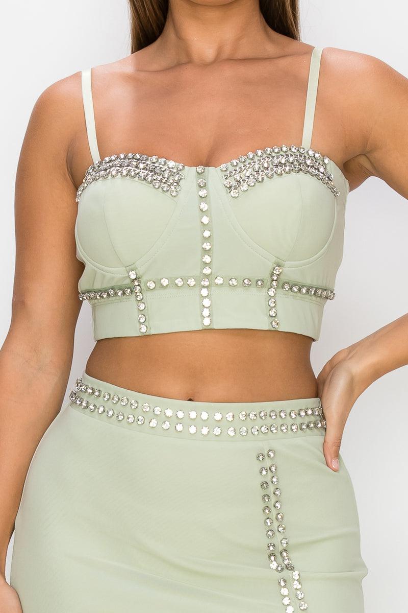 Light sage studded stone cami top and slit mini skirt set with mesh details and adjustable straps. Perfect for stylish summer wear.