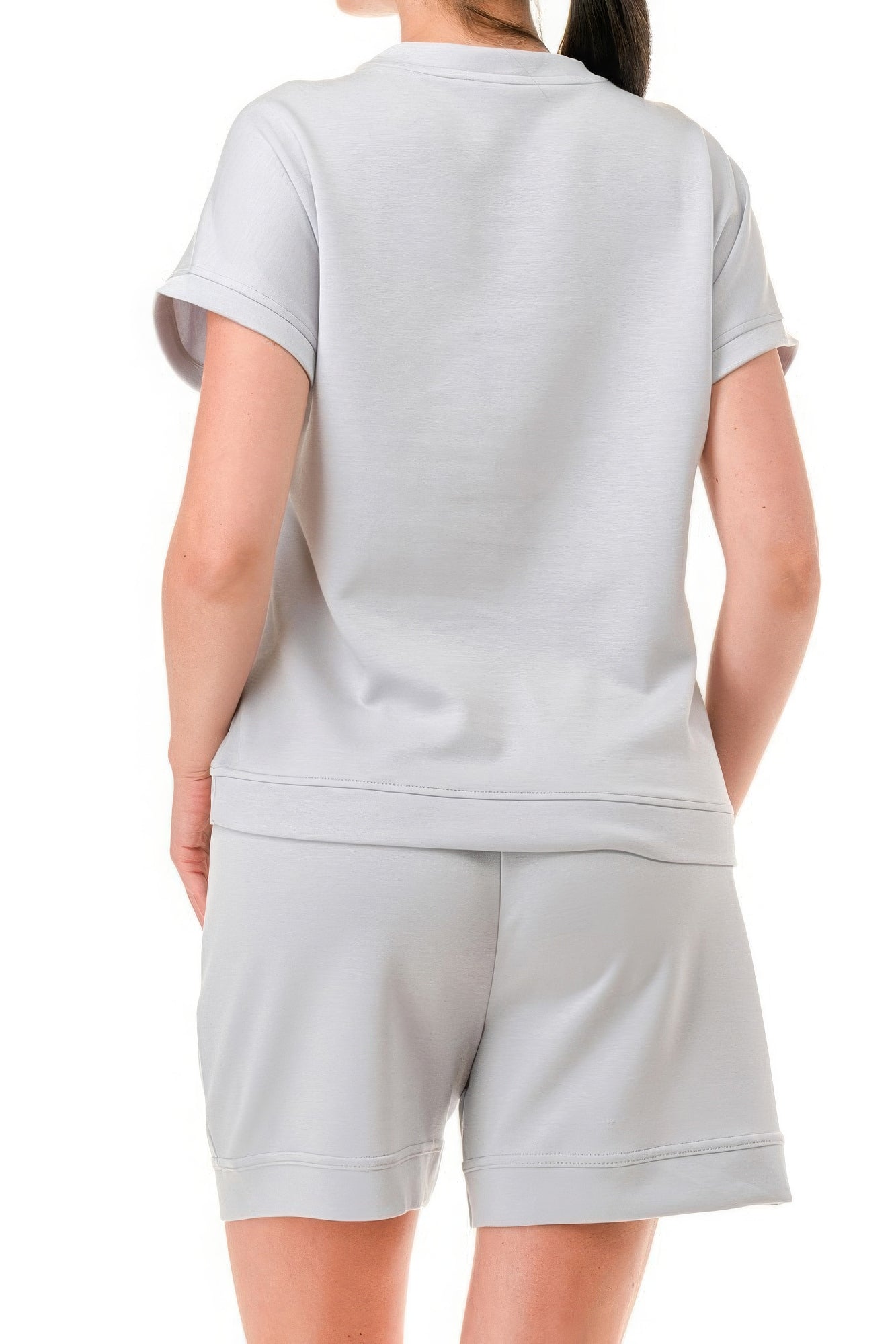 Woman wearing light grey Air Cotton Monochrome Tee and Shorts Set with round neck and trim detailing, showcasing back view.