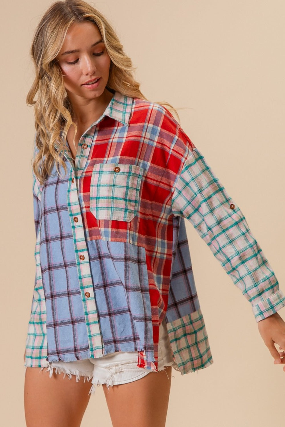 Woman wearing a colorful color block plaid button-down shirt made of 100% cotton, showcasing a casual and trendy style.