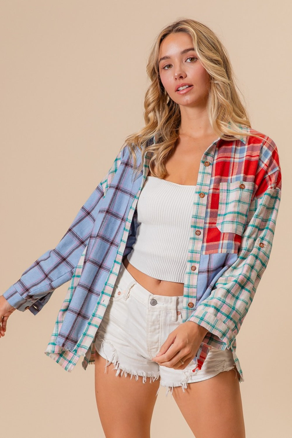 Color Block Plaid Button Down Shirt in 100% cotton, featuring a mix of red, blue, and green plaid patterns, worn over white shorts.