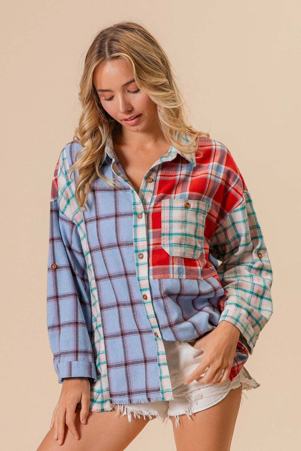 Woman wearing a color block plaid button-down shirt made of 100% cotton, showcasing stylish design with slight stretch for comfort.