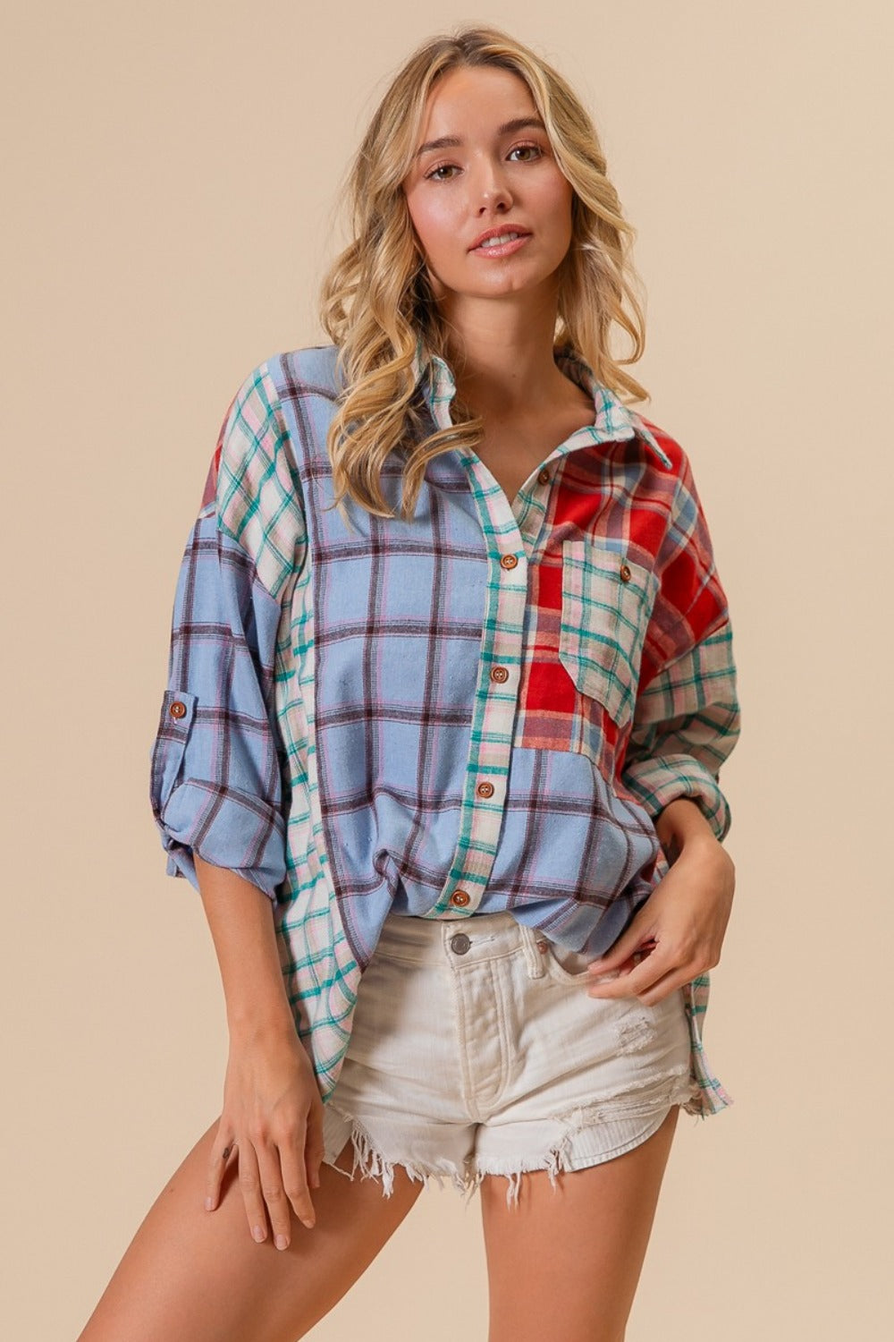 Woman wearing color block plaid button down shirt in 100% cotton, showcasing fashionable casual style with slight stretch material.