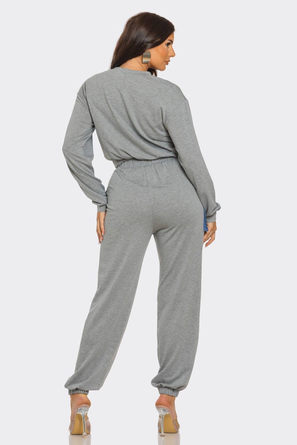 Woman modeling French Terry color block denim detail pants set with round neck and elastic waistband, rear view.