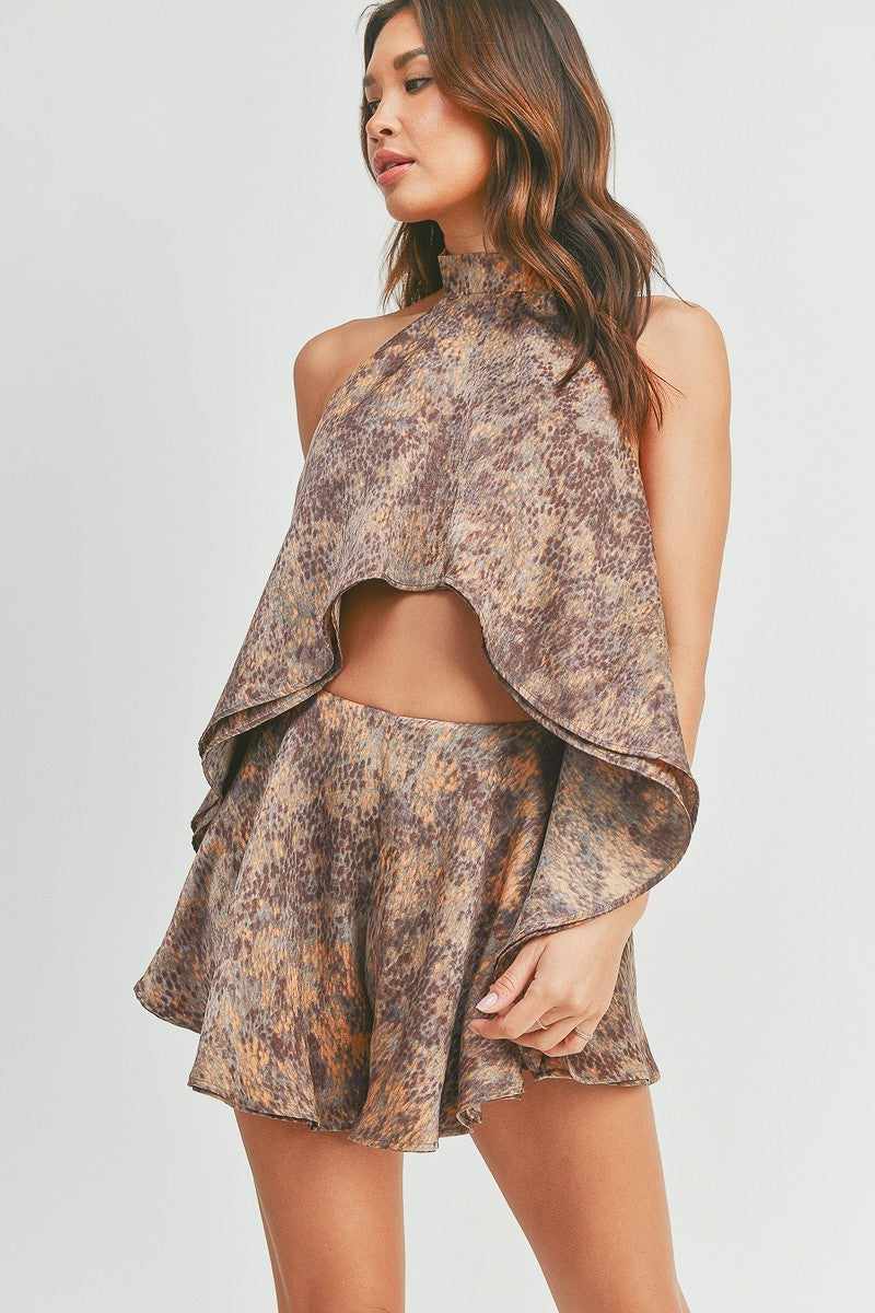 Woman wearing a stylish halter top skort set in earthy tones with a flowing design, perfect for a chic and comfortable look.