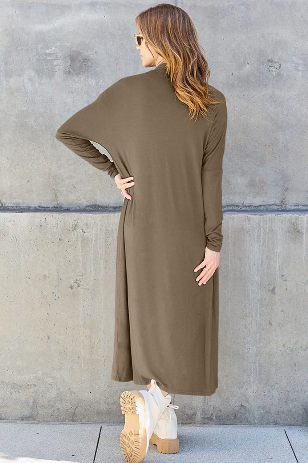 Woman modeling olive open front long sleeve cover up with back pocket detail, opaque and slightly stretchy.