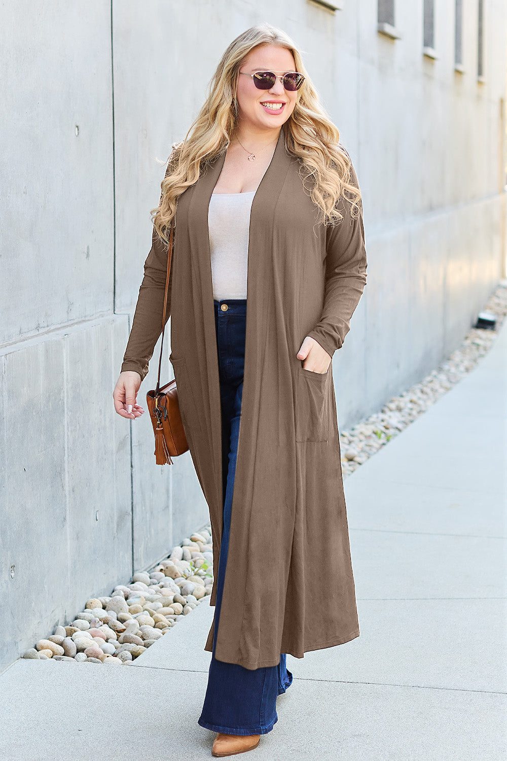 Woman wearing open front long sleeve cover up with pockets, stylish cardigan for casual outings.