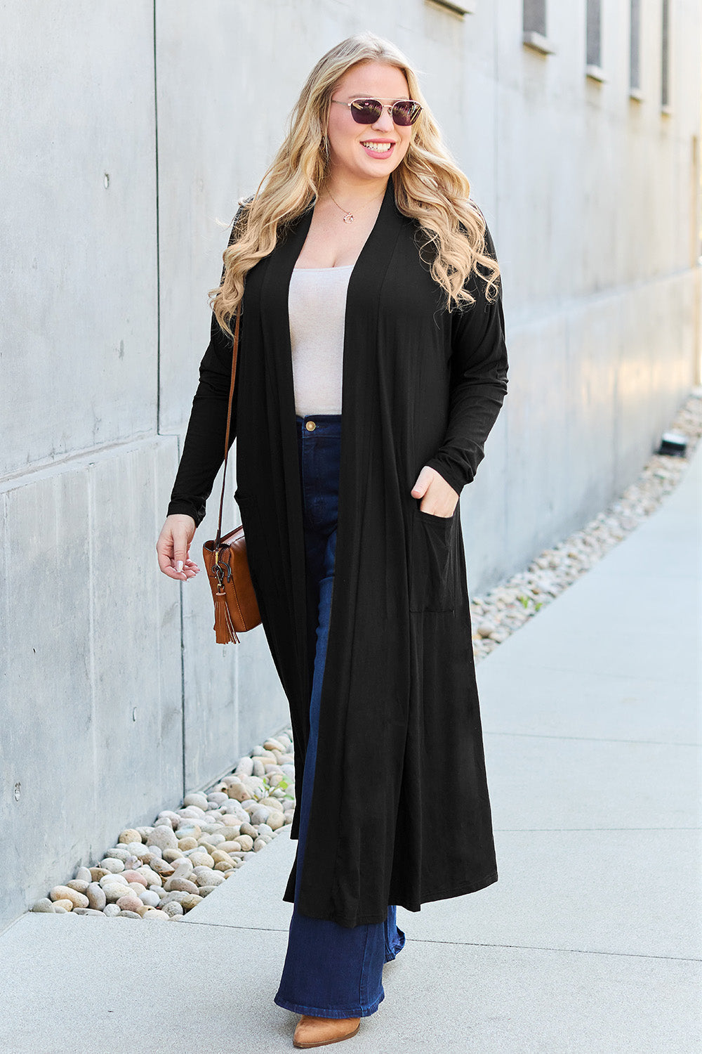 Woman wearing open front long sleeve cover-up with pockets, slightly stretchy rayon blend, stylish and casual outfit.