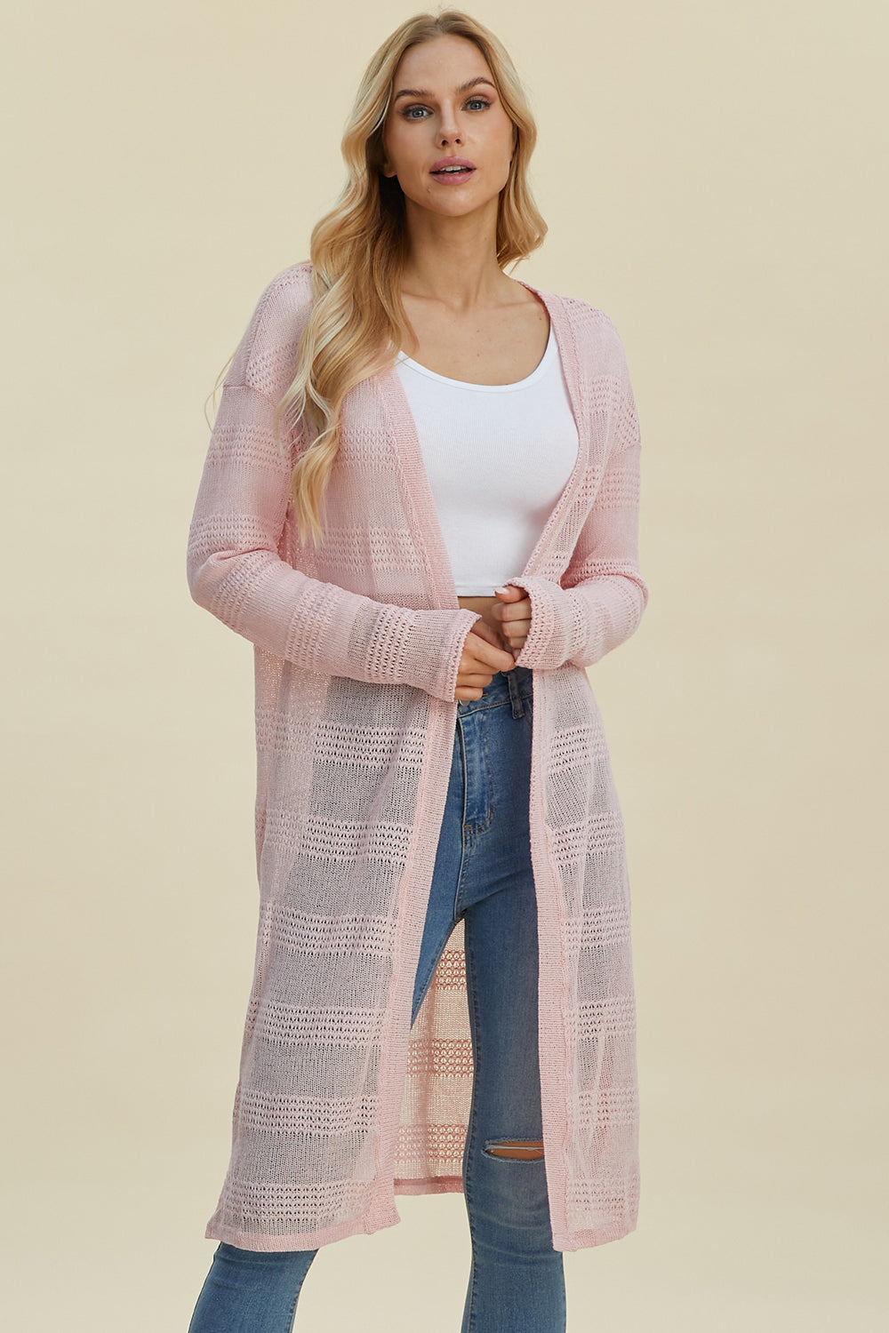 Open front longline cardigan in soft pink with openwork design, moderate stretch, and 100% polyester material.