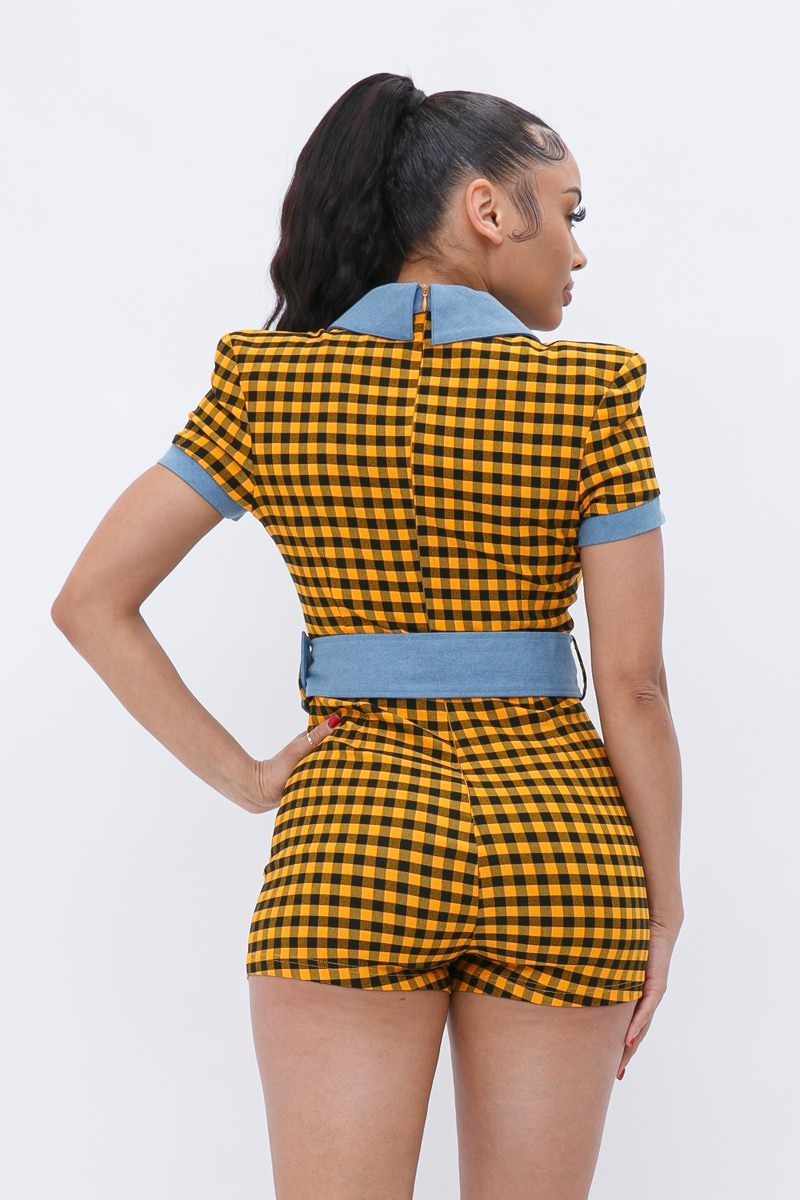 Woman wearing yellow plaid print denim romper with belt and button-up closure, showcasing back view and denim detailing.