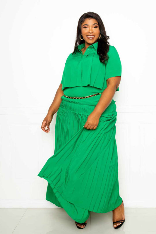 Plus size model in green pleated cropped shirt and maxi skirt set, size 1XL-3XL, showcasing stylish and comfortable fashion.