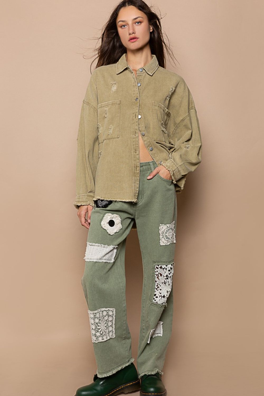 Woman wearing button down raw hem distressed shacket with patchwork pants, showcasing casual fashion style.