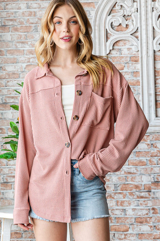 Woman wearing pink Reborn J button-up long sleeve shacket with denim shorts, perfect for casual style.