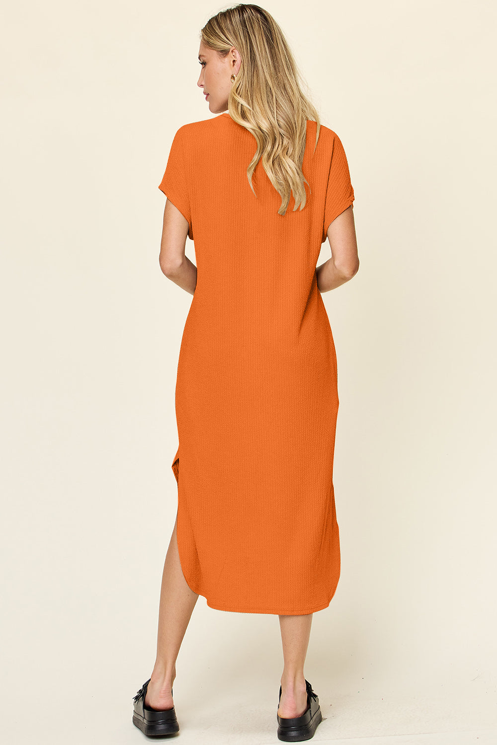 Orange round neck short sleeve slit dress, slightly stretchy, opaque polyester spandex blend, stylish and comfortable fashion.