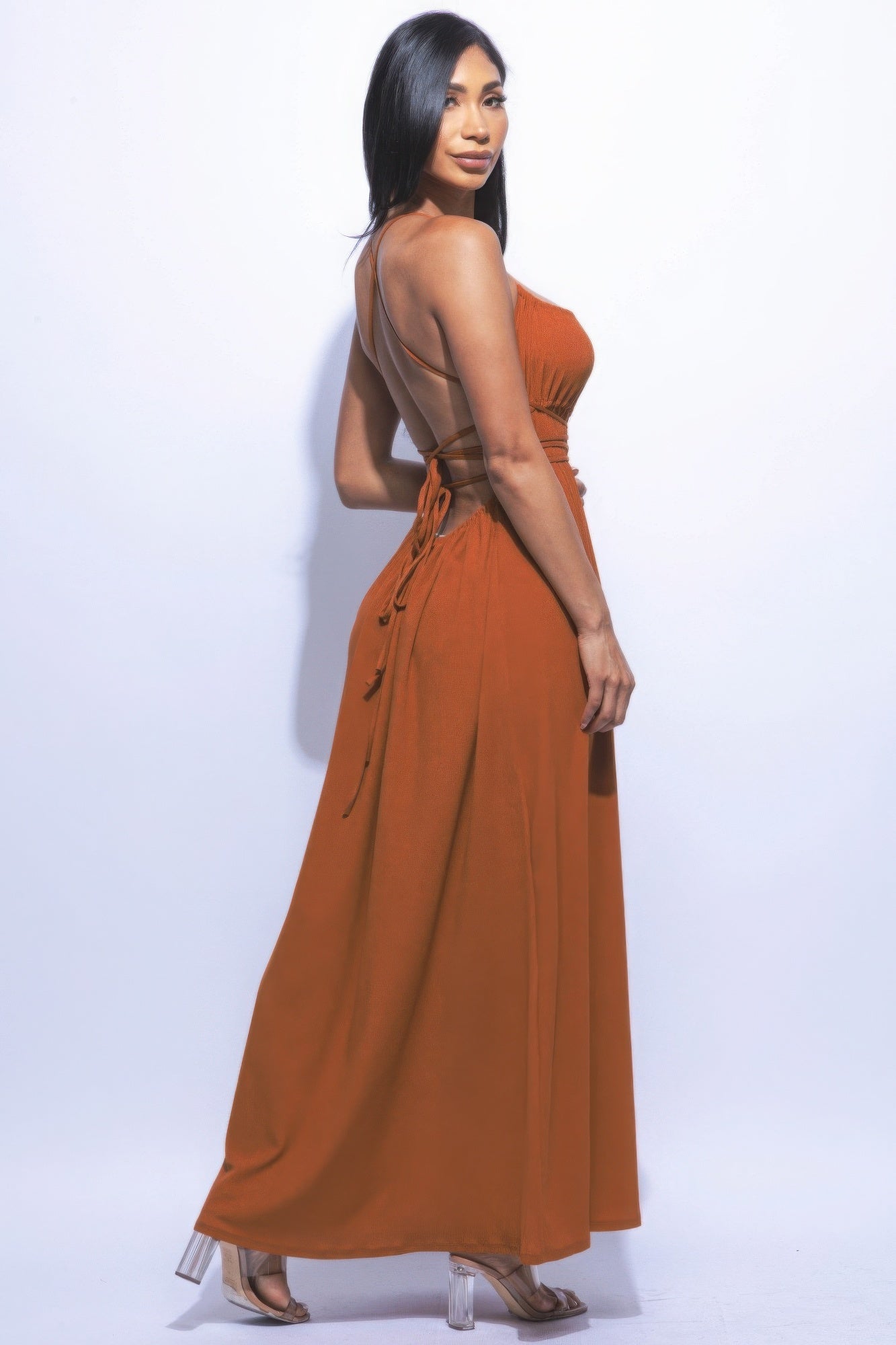 Woman wearing rust side slit maxi skirt with strappy tie back