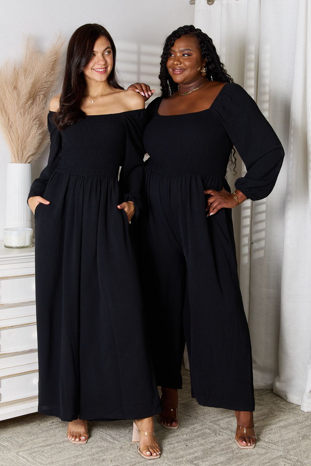 Women wearing black square neck jumpsuit with pockets and smocked bodice, showcasing chic and versatile style for all body types.