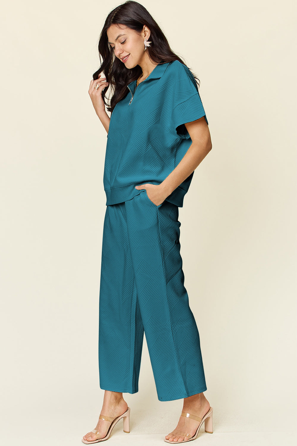 Woman wearing teal Texture Half Zip Short Sleeve Top and Pants Set with pockets and drawstring, made of polyester and spandex.