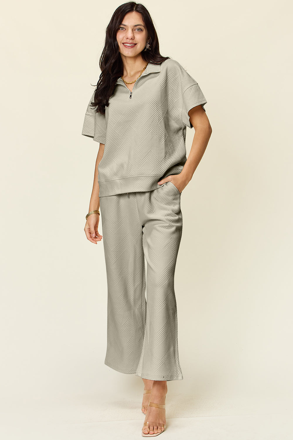 Two-piece texture half zip short sleeve top and pants set with pockets and drawstring, slightly stretchy polyester blend fabric.