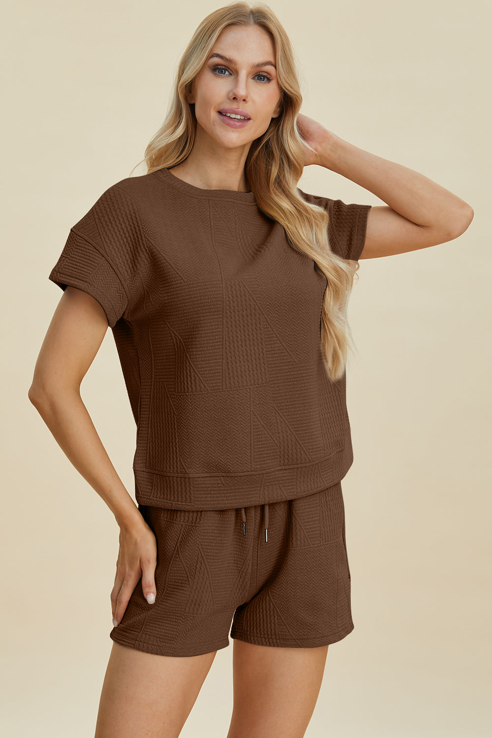 Brown full-size texture short sleeve top and shorts set with pockets and drawstring, made of 98% polyester and 2% elastane.