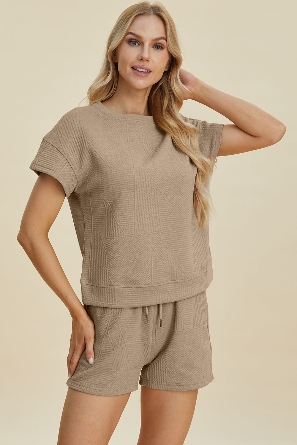 Woman wearing full size texture short sleeve top and shorts set with pockets and drawstring, slightly stretchy polyester blend.