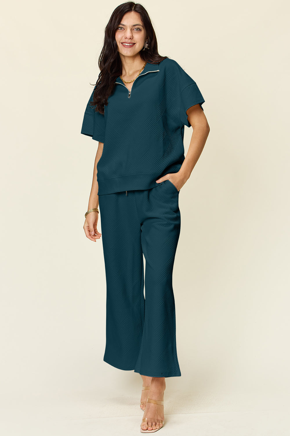 Woman wearing full size texture half zip short sleeve top and pants set with pockets, slightly stretchy polyester blend fabric.