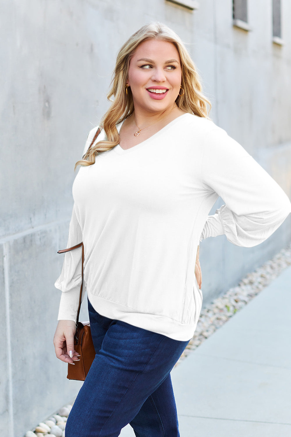 Woman wearing white V-Neck Lantern Sleeve Top with jeans, stylish casual outfit for everyday comfort