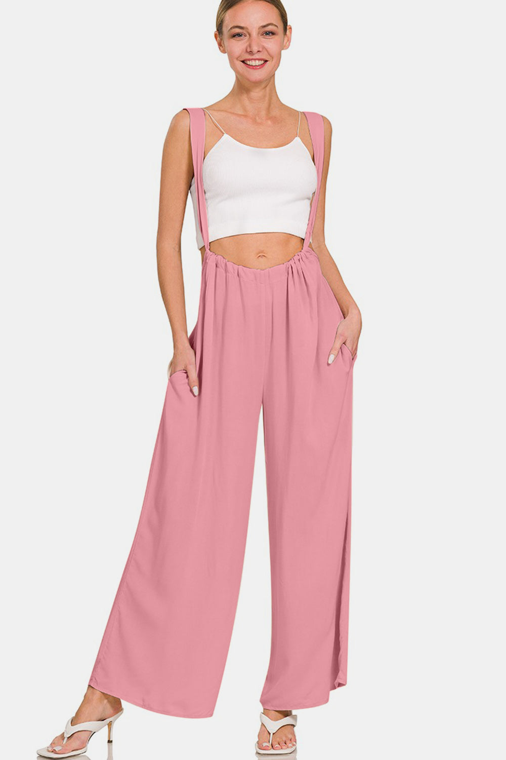 Trendy wide-leg pink overalls with wide straps and pockets, perfect for versatile day-to-night fashion in soft, breathable fabric.