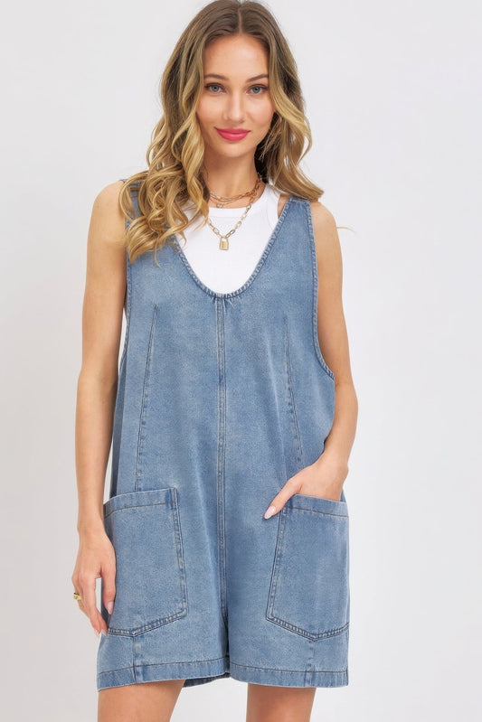 Woman wearing a summer denim overall romper with oversized pockets and adjustable straps, perfect for casual outings.