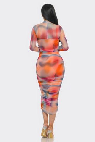 Woman wearing Summer Heat Print Mesh Ruched Midi Dress with vibrant tomato/purple colors, showcasing flattering ruched silhouette.