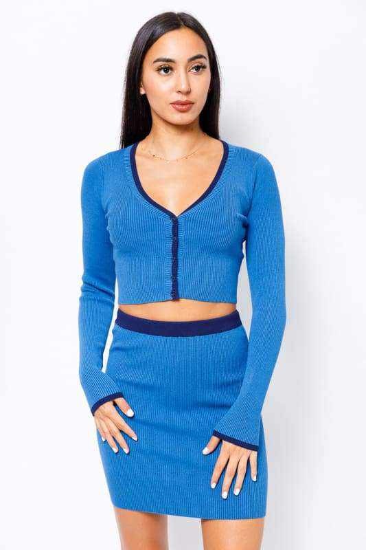 Woman wearing blue sweater two-piece set with long sleeve shirt and mini skirt made from rayon, nylon, and spandex blend.